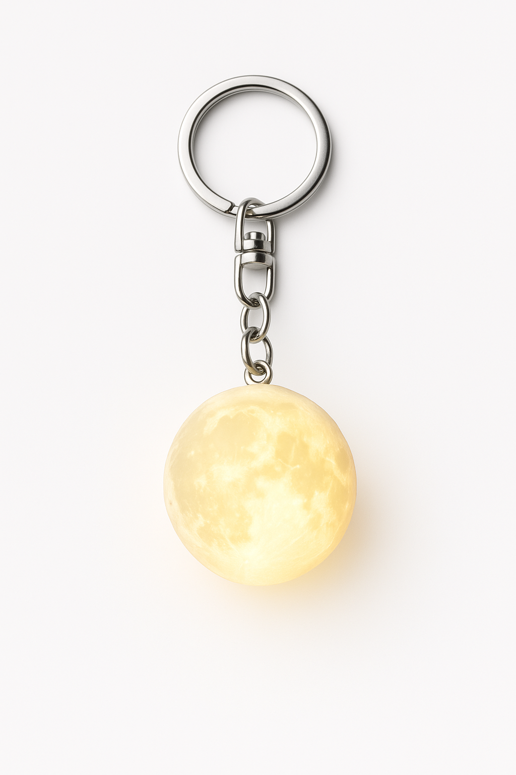 Mini moon lamp keychain glowing warm light on white background 3D printed lunar surface
